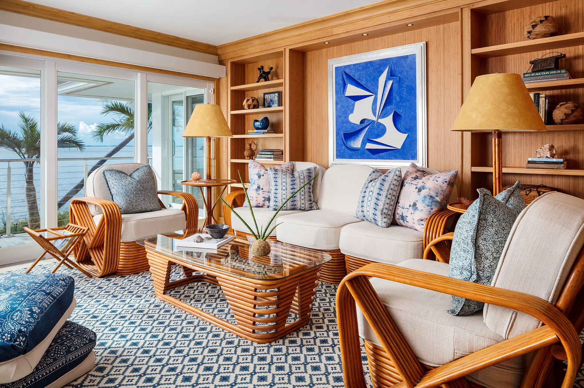 In this living room, we see displays of biophilic designs. With warm wood tone furniture and built in storage on the long wall, this space brings nature into the home.
